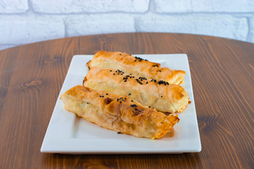 Delicious cheese pastry with black seed on top served on wood table