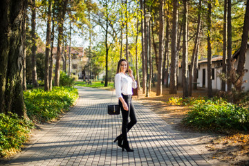 Photographing a girl during autumn with a blurred background