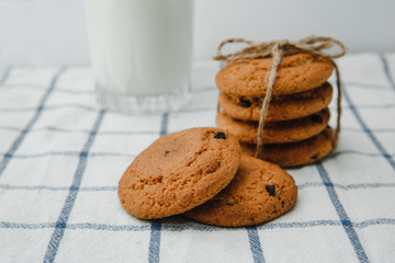Chocolate chip cookies with milk on towel