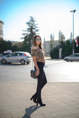 Photographing a girl during autumn with a blurred background