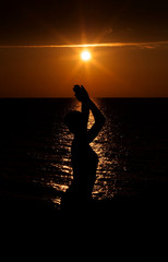 silhouette of woman on sunset