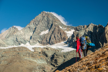 Two alpinists watching Grossglockner peak in autumn, East Tyrol, Hohe Tauern, Austria