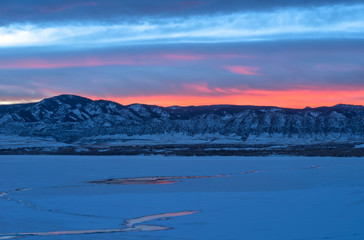 Sunset Winter Mountain Lake - Colorful sunset at a frozen mountain lake. Chatfield Reservoir in Chatfield State Park, southwest of Denver-Littleton, Colorado, USA.