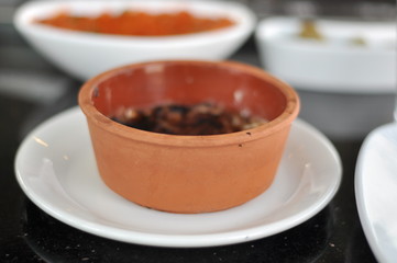 Traditional Cypriot meze and mix meat and chicken kebab table with charcoal barbecue on the table for self cooking during the eating time