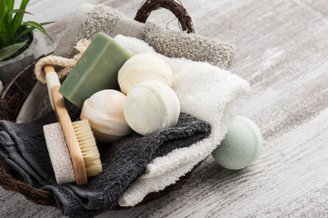 Folded towels in bascket with bath bombs