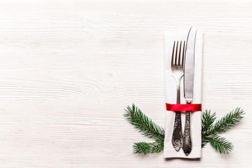 Christmas table setting conceptual design with fork, knife and festive attributes. New Year banquet serving appointment options with silverware. Background, close up, top view, flat lay, copy space.
