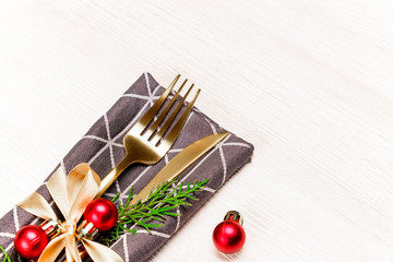 Christmas table setting conceptual design with fork, knife and festive attributes. New Year banquet serving appointment options with silverware. Background, close up, top view, flat lay, copy space.