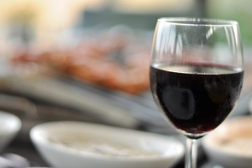 Traditional Cypriot meze and mix meat and chicken kebab table with charcoal barbecue on the table for self cooking during the eating time