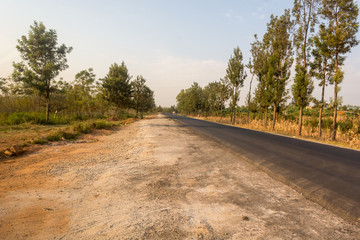 Newly built road crossing savannah countryside making transportation possible.