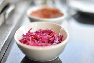 Traditional Cypriot meze and mix meat and chicken kebab table with charcoal barbecue on the table for self cooking during the eating time