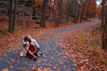 Fototapeta premium Beautiful woman in coat in the autumn forest.