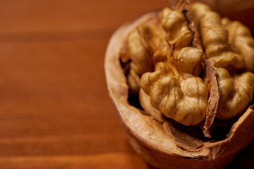Walnut on brown wooden background. Selective focus
