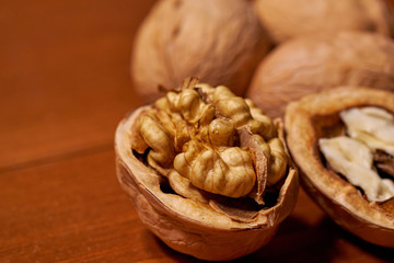 Walnut on brown wooden background. Selective focus