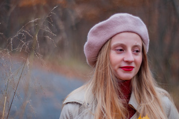 Beautiful elegant woman in the park in autumn