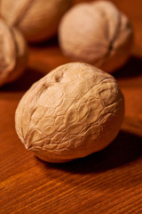 Walnut on brown wooden background. Selective focus