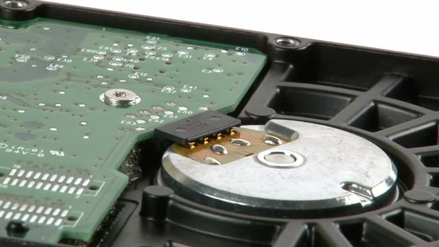 A close up of all the details that are on the circuit boad  of a hard drive.