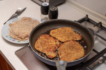 Preparing a pork chop in a home kitchen. Ingredients for a tasty dinner after work.
