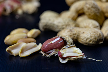 Peanuts on a black kitchen table. Tasty ingredients for peanut butter.
