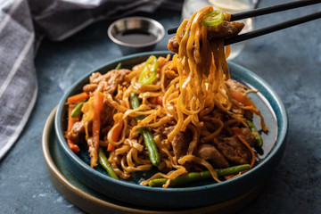 Asian noodles with pork in teriyaki sauce, with green beans, carrots and shiitake mushrooms.