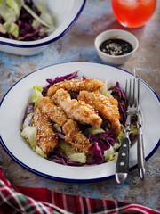 Salad with warm glazing chicken, sprinkled with sesame seeds. Chinese cuisine. Asian culture