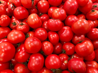 Healthy eating and vegetarian food concept - close up sweet red tomatoes