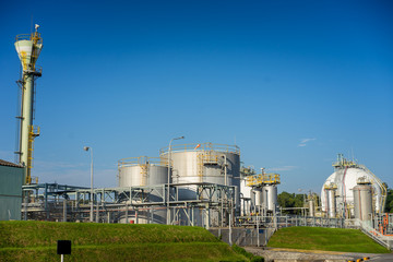 Close up Industrial view at oil refinery plant and silos form industry zone with blue sky