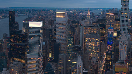 AERIAL: Illuminated New York City skyscrapers in Midtown Manhattan at night