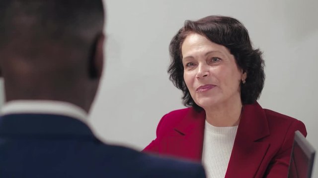Elderly caucasian woman listening to the advice of lawyer