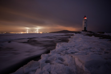 Aerial winter view of the Tokarevskiy lighthouse - one of the oldest lighthouses in the Far East, still an important navigational structure and popular attractions of Vladivostok city, Russia.	