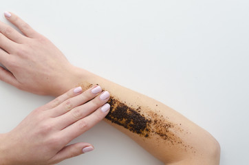 Woman using natural eco body scrub coffee Gently Exfoliates isolated on white