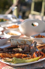 Traditional Cypriot meze and kebap barbecue party in the garden with delicious mix meat and chicken kebaps