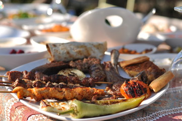 Traditional Cypriot meze and kebap barbecue party in the garden with delicious mix meat and chicken kebaps