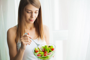 Diet and health.Young woman eating healthy food after workout