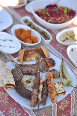 Traditional Cypriot meze and kebap barbecue party in the garden with delicious mix meat and chicken kebaps