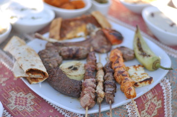 Traditional Cypriot meze and kebap barbecue party in the garden with delicious mix meat and chicken kebaps
