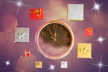 Clock and christmas gift boxes on  holiday background. Top view.
