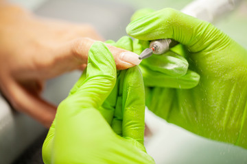 Manicure. Nails master doing manicure in beauty studio