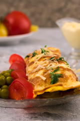 Omelet roll. Sliced Tomatoes Marinated green peas. Vertical. Light background.