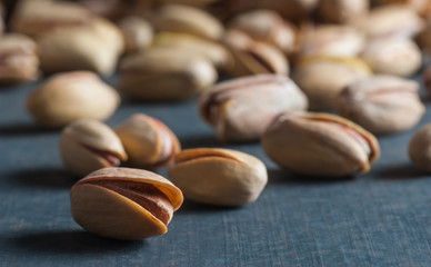 Pistachio in nutshell on black wooden rustic backdrop, composition of pistachios great for healthy and dietary nutrition. Concept of nuts
