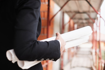 Woman Working As Engineer Holding Building Plans