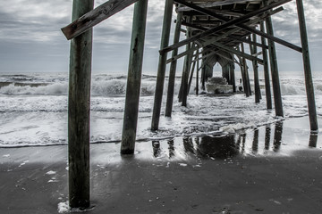 Crashing waves under the pier