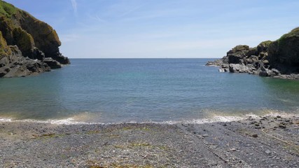 Beautiful view of the sea from Cadgwith Cove beach, on a hot summer day.