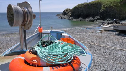 Detail of rope and lifesaver ring in a small fishing boat on Cadgwith Cove beach (rack focus).
