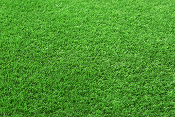 Artificial grass carpet as background, closeup. Exterior element