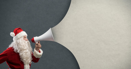 Santa Claus announcing a message with a megaphone