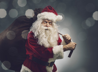 Santa Claus carrying a sack with Christmas gifts