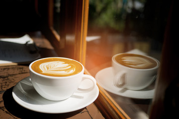 hot latte art coffee on wood table, relax time