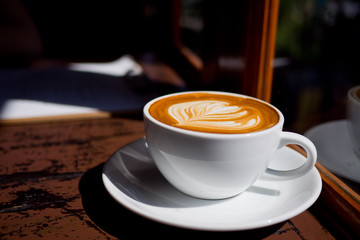 hot latte art coffee on wood table, relax time