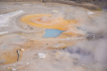 Yellowstone's geothermal features create colorful, abstract patterns
