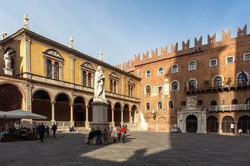Naklejka na ściany i meble Statue of Dante Alighieri in Piazza dei Signori, Verona, Italy-23 ottobre 2018. Beautiful statues of Dante in the middle of Verona old town with other sculptures and architecture. Summer day in Verona